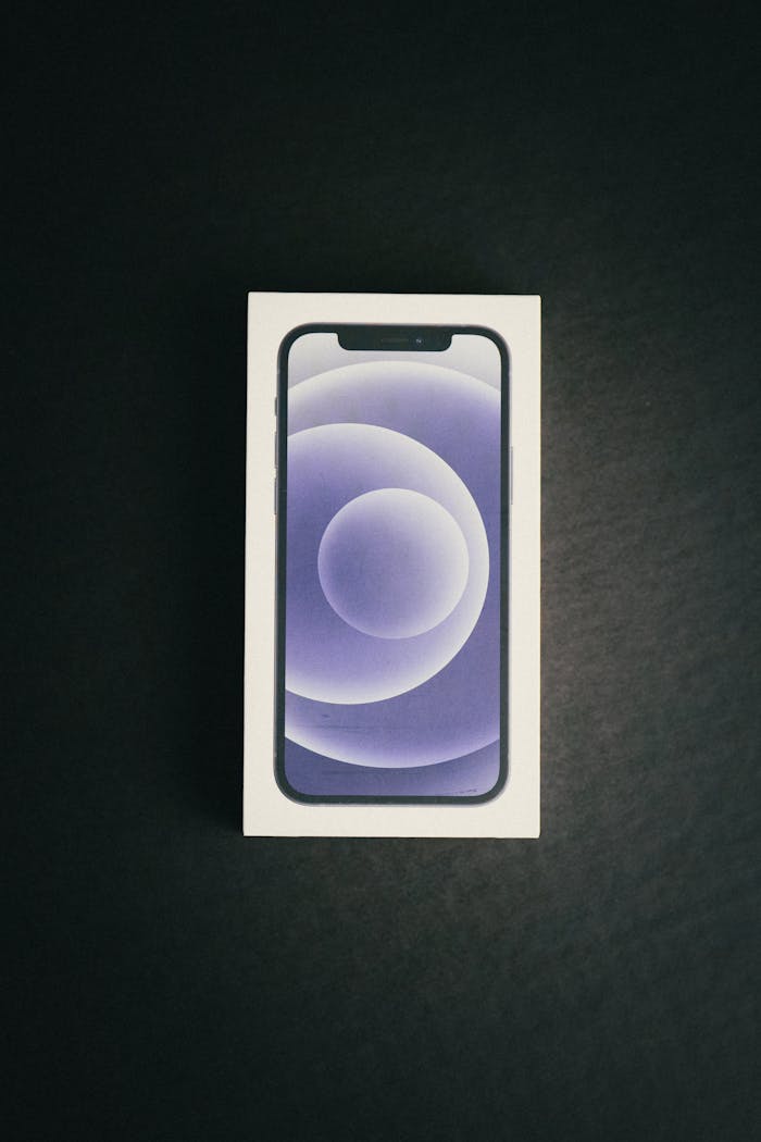 A new smartphone in its packaging on a black background, showcasing latest technology.