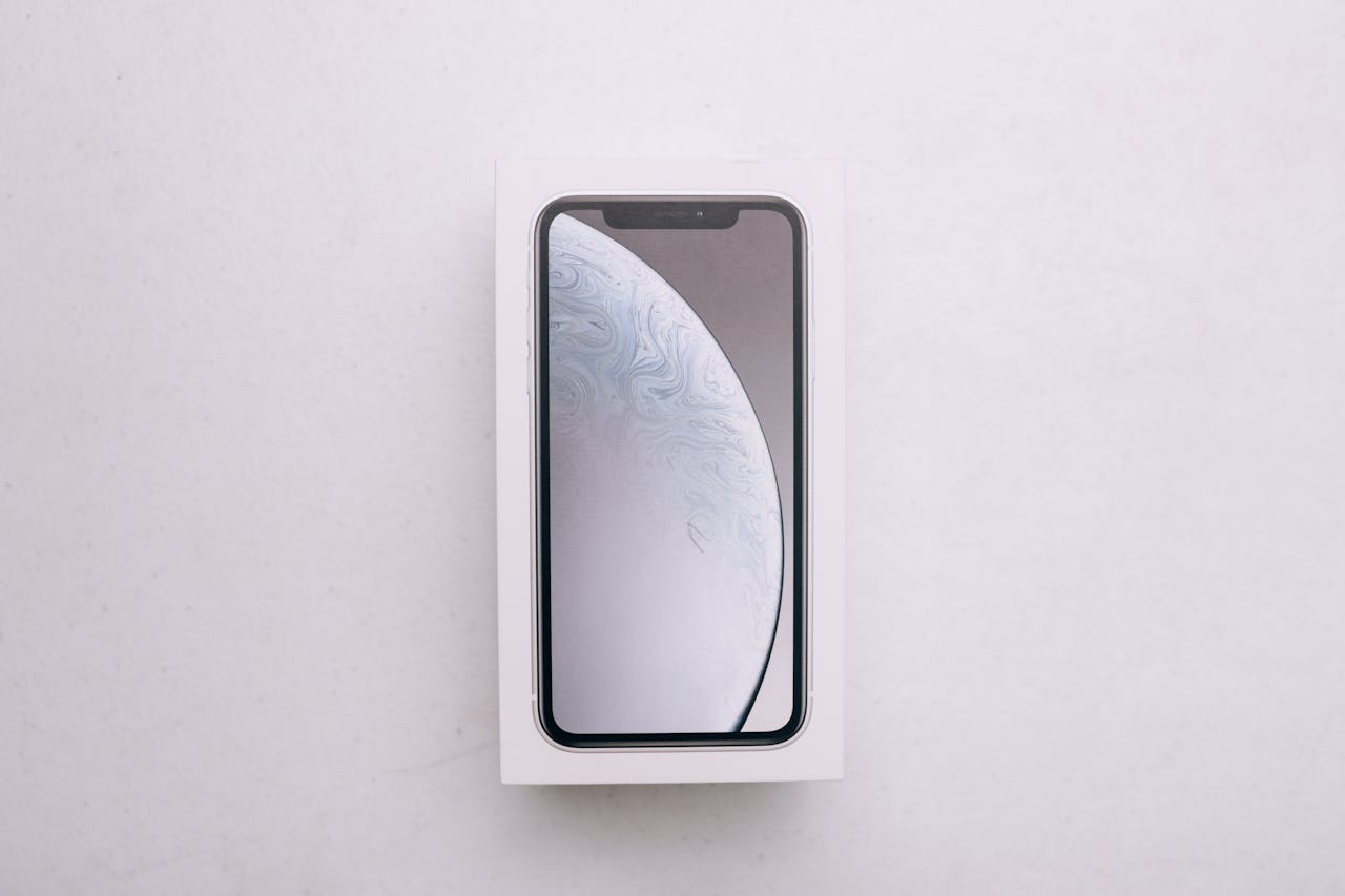 High-quality image of a boxed smartphone placed on a white background.